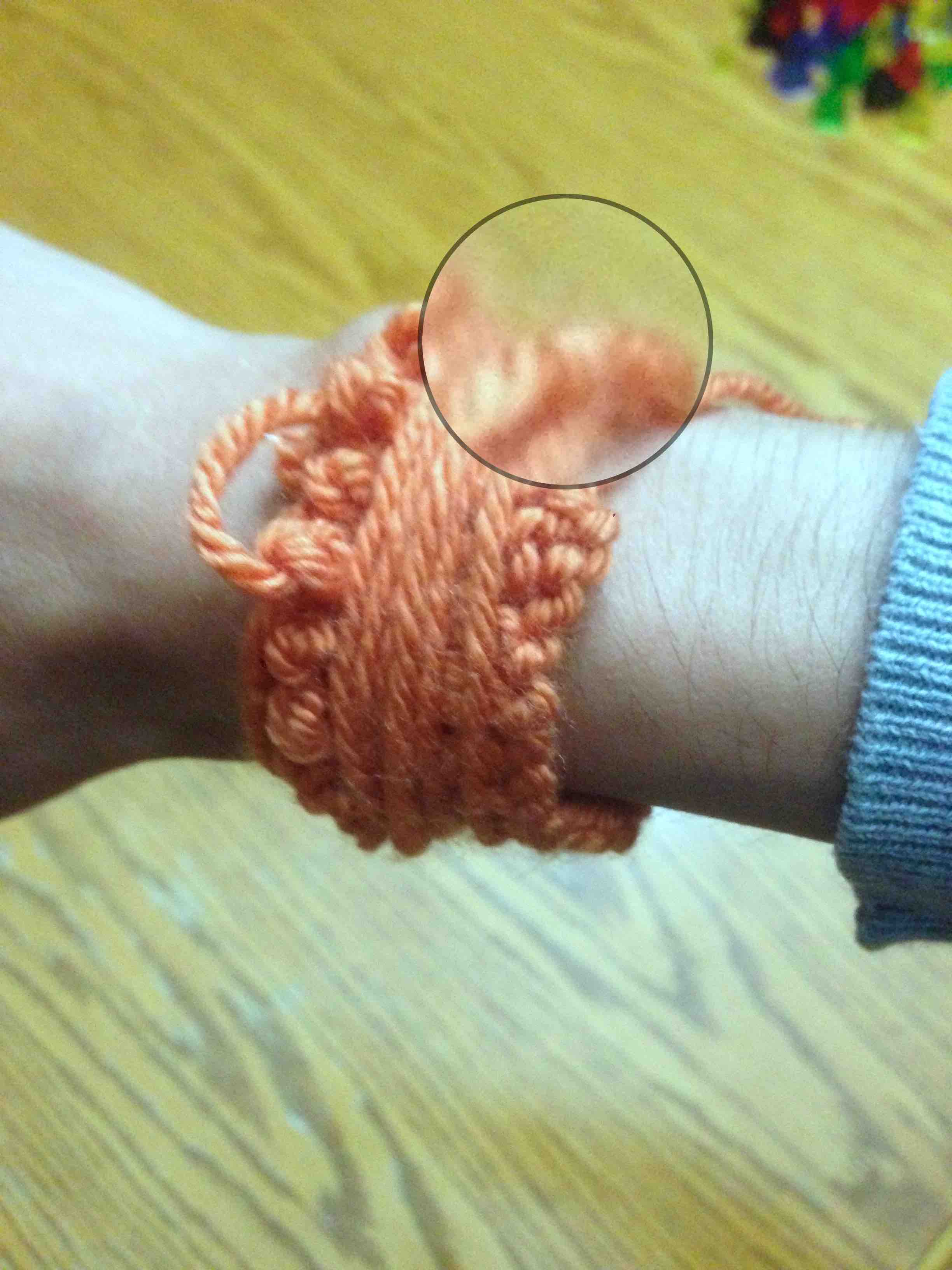 An orange yarn bracelet